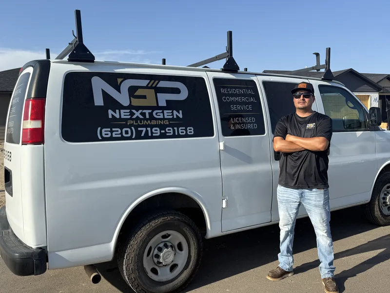 NextGen Plumbing owner wearing sunglasses beside the company service van
